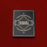 A deck of cards with the League of Legends wordmark on them against a red background