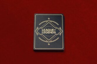 A deck of cards with the League of Legends wordmark on them against a red background