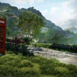 A red phone booth sits on a country lane that